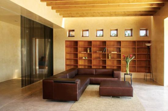 Integral-color concrete floors, plaster walls coated in polished beeswax reduce the need for conventional finishes.