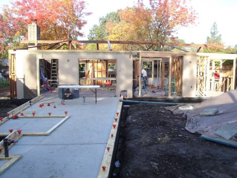 Light Exposure. The retrofit will retain 100% of the house's foundation and 40% of its walls. It is connecting two buildings that comprise the house via a breezeway (left) that leads into a courtyard. The completed retrofit will have 2,400 square feet of living space with an attached garage.
