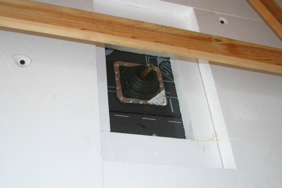 Attention To Detail. A boot vent for plumbing penetration through the garage illustrates the level of installation care that is needed to get the right air tightness for the house to meet Passive House's rigorous air-exchange standards.
