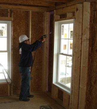 A contractor&nbsp;performs air sealing with Owens Corning's EnergyComplete system.